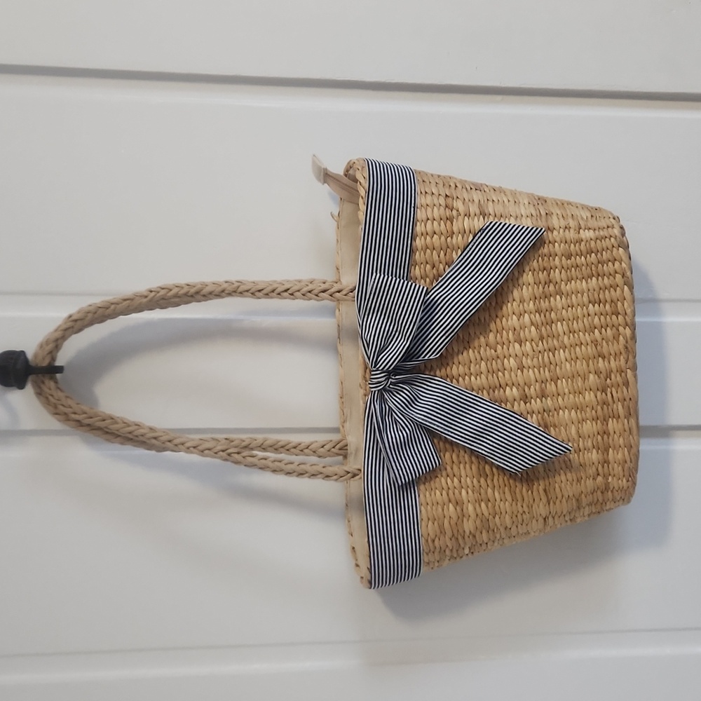 Straw bag w/ black & white striped bow.